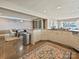 Open concept eat in kitchen with white cabinetry, large center island, and direct access to dining area at 3030 Point Clear Dr, Tega Cay, SC 29708