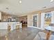 Open-concept kitchen featuring tiled floors, lots of counter space, stainless steel appliances, and backyard access at 3030 Point Clear Dr, Tega Cay, SC 29708