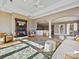 Comfortable living room features a fireplace, hardwood floors, and plenty of natural light and open to other rooms at 3030 Point Clear Dr, Tega Cay, SC 29708
