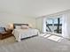Bright main bedroom features lake views, neutral tones, and plush carpeting at 3030 Point Clear Dr, Tega Cay, SC 29708