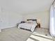 Spacious carpeted main bedroom with neutral decor and a full-length window at 3030 Point Clear Dr, Tega Cay, SC 29708