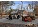 Rear exterior of home showcasing backyard firepit and seating area with a woodpile for cozy outdoor gatherings at 341 Beckwick Ln, Concord, NC 28025