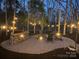 Backyard patio featuring gravel, chairs, strung lights, and a wooden bar for a relaxed outdoor experience at 341 Beckwick Ln, Concord, NC 28025