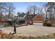 Expansive backyard with patio, basketball hoop, garage, and landscaping perfect for outdoor living and entertaining at 341 Beckwick Ln, Concord, NC 28025