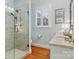 Elegant bathroom featuring a glass-enclosed shower, marble countertops, and stylish fixtures at 341 Beckwick Ln, Concord, NC 28025