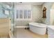 Bathroom featuring a modern soaking tub, walk-in shower, and detailed wallpaper at 341 Beckwick Ln, Concord, NC 28025