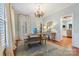 Dining room featuring wooden table with bench seating, chandelier, and view of the kitchen at 341 Beckwick Ln, Concord, NC 28025