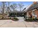 Back of house with a glass-enclosed sunroom, patio furniture, and a lush garden at 341 Beckwick Ln, Concord, NC 28025