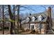 Beautiful brick home with classic dormers, mature trees, and well-maintained landscaping at 341 Beckwick Ln, Concord, NC 28025