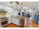 Well-lit kitchen with white cabinets, stainless steel appliances, and granite countertops at 341 Beckwick Ln, Concord, NC 28025