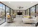 Bright living room features floor-to-ceiling windows, contemporary furnishings, and views of a wooded backyard at 341 Beckwick Ln, Concord, NC 28025