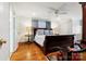 Spacious main bedroom with wood floors, a ceiling fan, and a large wooden bed frame at 341 Beckwick Ln, Concord, NC 28025