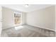 Bright bedroom featuring a large window and neutral carpet at 345 Briar Creek Rd, Gastonia, NC 28056