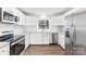 Bright kitchen with white cabinets, stainless steel appliances, and hardwood floors at 345 Briar Creek Rd, Gastonia, NC 28056