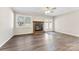 Cozy living room featuring a brick fireplace, hardwood floors, and natural light at 345 Briar Creek Rd, Gastonia, NC 28056