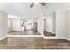 Open-concept living and kitchen area with hardwood floors and modern white cabinets at 345 Briar Creek Rd, Gastonia, NC 28056