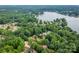 Aerial view of a home in a lush, green neighborhood near a lake at 3675 West Bay Dr, Sherrills Ford, NC 28673