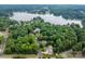 Aerial view of a home in a lush, green neighborhood near a lake at 3675 West Bay Dr, Sherrills Ford, NC 28673