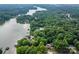 Aerial view of wooded property, lakefront, and docks at 3675 West Bay Dr, Sherrills Ford, NC 28673