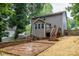 Spacious backyard featuring a stone patio and steps to an upper wood deck at 3675 West Bay Dr, Sherrills Ford, NC 28673
