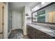 Bathroom featuring double vanity, granite countertop, framed mirror, and tiled glass shower at 3675 West Bay Dr, Sherrills Ford, NC 28673