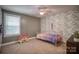 Bedroom featuring floral accent wall, decorative window blinds, and pink furniture at 3675 West Bay Dr, Sherrills Ford, NC 28673