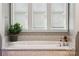 Close-up of elegant bathroom features a luxurious soaking tub with mosaic tile surround at 401 Pecan Ridge Ct, Weddington, NC 28104