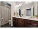 A clean, double sink bathroom features dark wood cabinets and a neutral countertop at 401 Pecan Ridge Ct, Weddington, NC 28104