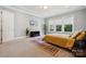 Cozy bedroom showcasing carpet, natural light from windows, and a television at 401 Pecan Ridge Ct, Weddington, NC 28104