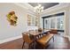 Beautiful dining room featuring hardwood floors, built-in shelving and an elegant chandelier at 401 Pecan Ridge Ct, Weddington, NC 28104