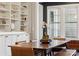 Dining room featuring built-in shelving and dark trim around windows and entryway at 401 Pecan Ridge Ct, Weddington, NC 28104