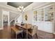 Open dining room with hardwood floors, built-in shelving, and elegant chandelier at 401 Pecan Ridge Ct, Weddington, NC 28104