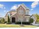 Beautiful home featuring a combination of stone and siding, complemented by manicured landscaping at 401 Pecan Ridge Ct, Weddington, NC 28104