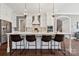 Kitchen featuring a large island with barstool seating, white cabinetry, and modern stainless steel appliances at 401 Pecan Ridge Ct, Weddington, NC 28104