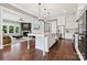 Modern kitchen open to the living room, featuring an island with barstool seating at 401 Pecan Ridge Ct, Weddington, NC 28104