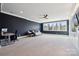 A living room with blue accent walls has a fan and view of the yard at 401 Pecan Ridge Ct, Weddington, NC 28104