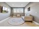 A living room has neutral walls, a decorative rug, and is well lit with natural light at 401 Pecan Ridge Ct, Weddington, NC 28104