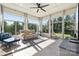 Bright sunroom filled with windows and natural light with comfortable furniture at 401 Pecan Ridge Ct, Weddington, NC 28104