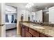 The bathroom features dual sinks, granite counters, wood cabinets, and a bedroom view at 4224 Park South Station Blvd, Charlotte, NC 28210