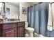 Well-lit bathroom features granite vanity and blue shower curtain at 4224 Park South Station Blvd, Charlotte, NC 28210