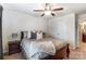 This bedroom features a ceiling fan and a view to an attached bathroom at 4224 Park South Station Blvd, Charlotte, NC 28210