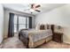 This bedroom features large windows, a ceiling fan, and a nightstand at 4224 Park South Station Blvd, Charlotte, NC 28210