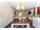 Bright dining area with hardwood floors, a chandelier, and a view of the living room at 4224 Park South Station Blvd, Charlotte, NC 28210