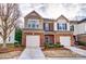 Charming townhome showcasing brick facade, manicured landscaping, and attached garages at 4224 Park South Station Blvd, Charlotte, NC 28210