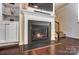 Elegant fireplace with dark floors, modern design, and adjacent built-in shelving at 4224 Park South Station Blvd, Charlotte, NC 28210