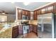 Kitchen features granite countertops, stainless steel appliances, and rich wood cabinets at 4224 Park South Station Blvd, Charlotte, NC 28210
