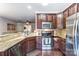 Open kitchen showcasing granite counters, stainless appliances and seamless flow to living spaces at 4224 Park South Station Blvd, Charlotte, NC 28210