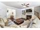 Open-concept living room featuring a fireplace, dark floors, gray sofas, and neutral paint at 4224 Park South Station Blvd, Charlotte, NC 28210