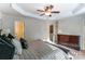 This main bedroom has large windows, a dresser, and a ceiling fan at 4224 Park South Station Blvd, Charlotte, NC 28210
