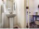 Elegant powder room with a pedestal sink, modern fixtures, and stylish decor at 4224 Park South Station Blvd, Charlotte, NC 28210